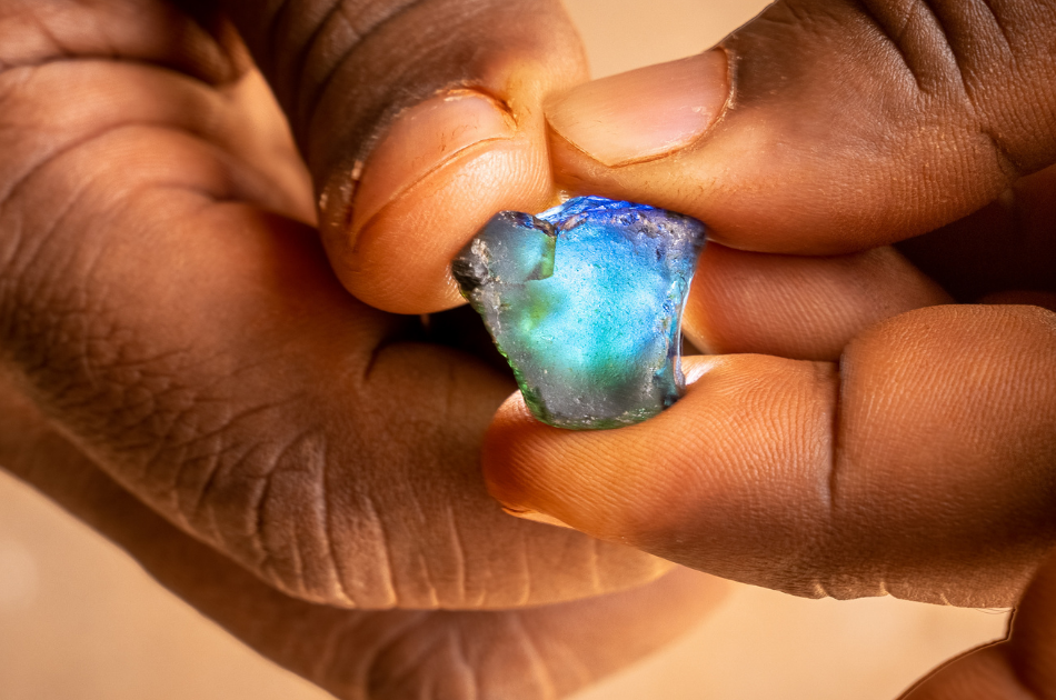 Hands holding Fura Australian sapphire rough stone